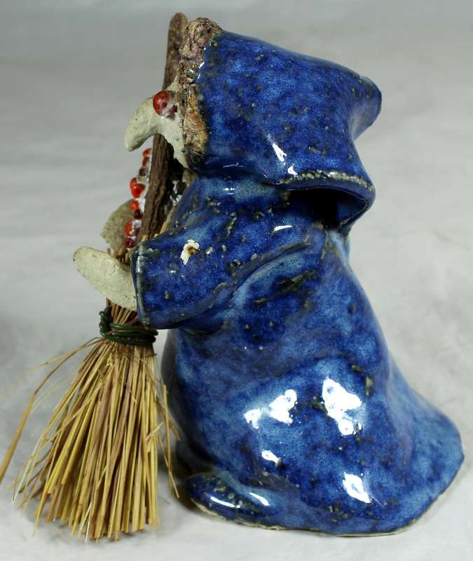 Pottery witch with broom in blue coat