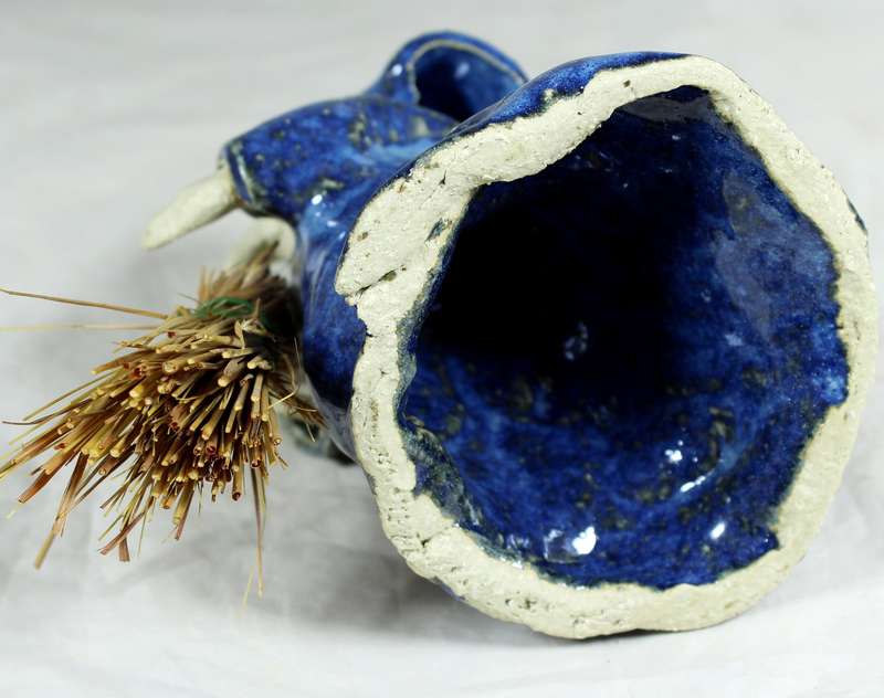 Pottery witch with broom in blue coat