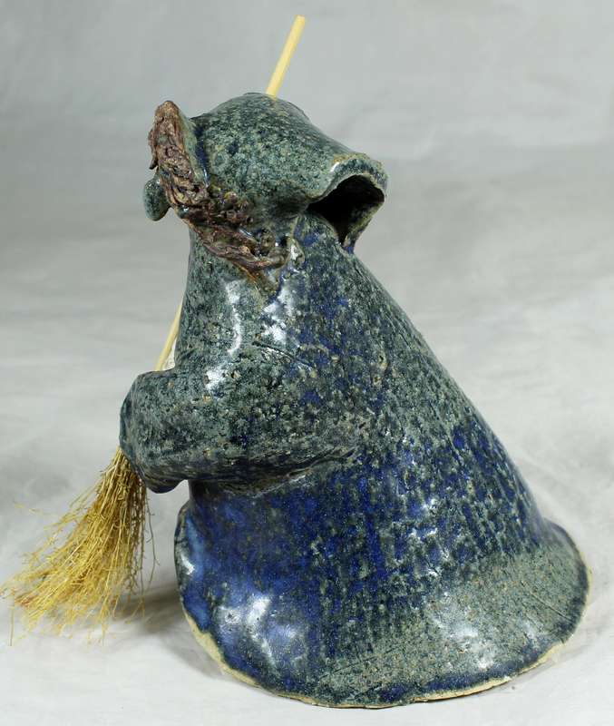 Pottery witch with broom in blue/green coat