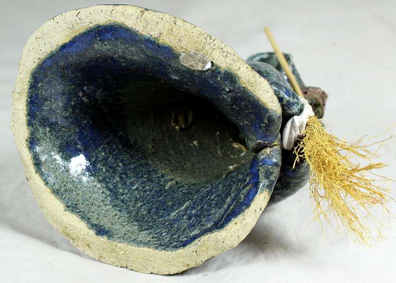 Pottery witch with broom in blue/green coat