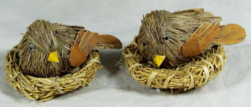 Pair of straw based birds on nests