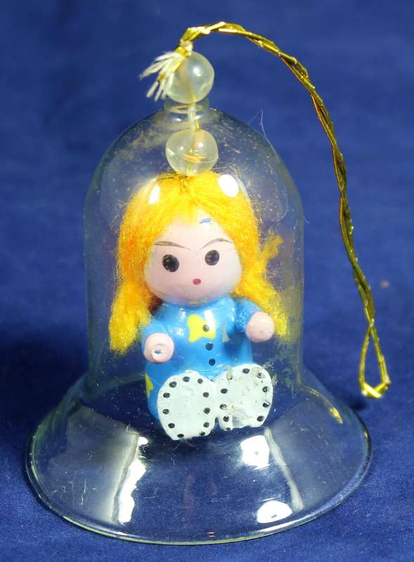 Vintage wooden doll in glass dome