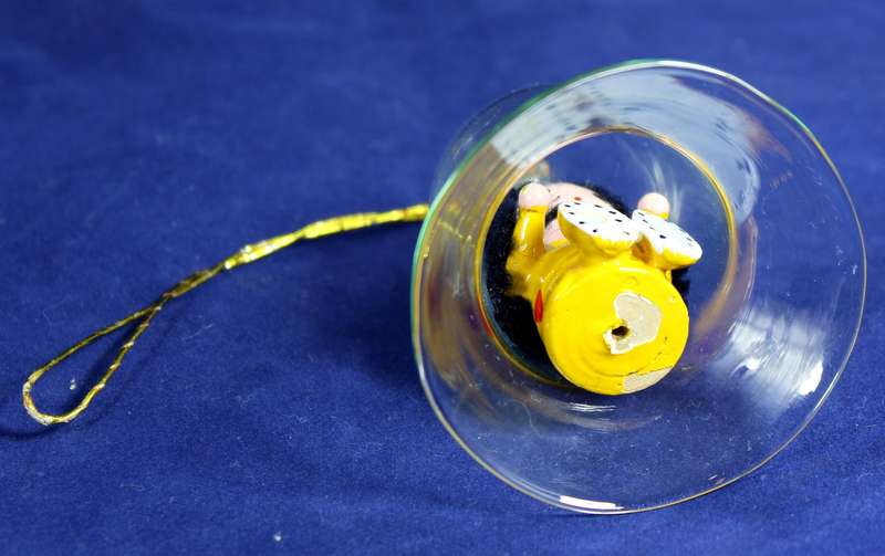 Vintage wooden doll in a glass dome
