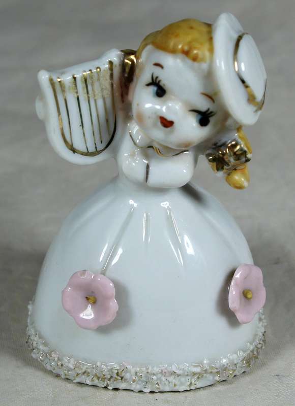 Little girl playing a harp bell