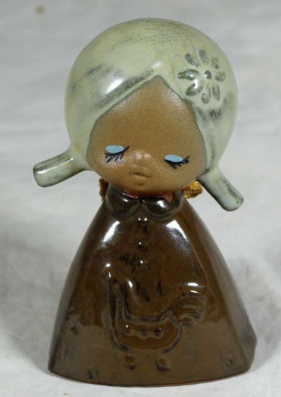 Glazed pottery bell of a little girl