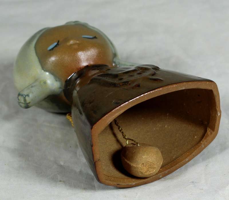 Glazed pottery bell of a little girl