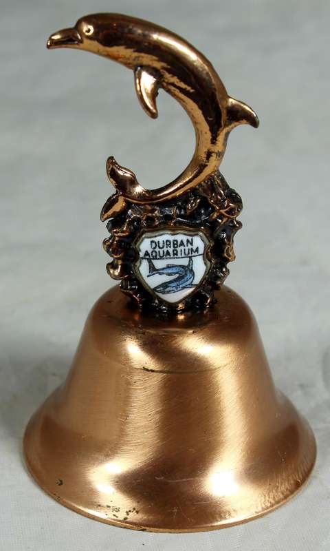 Souvenir copper bell - Durban aquarium with dolphin topped figure