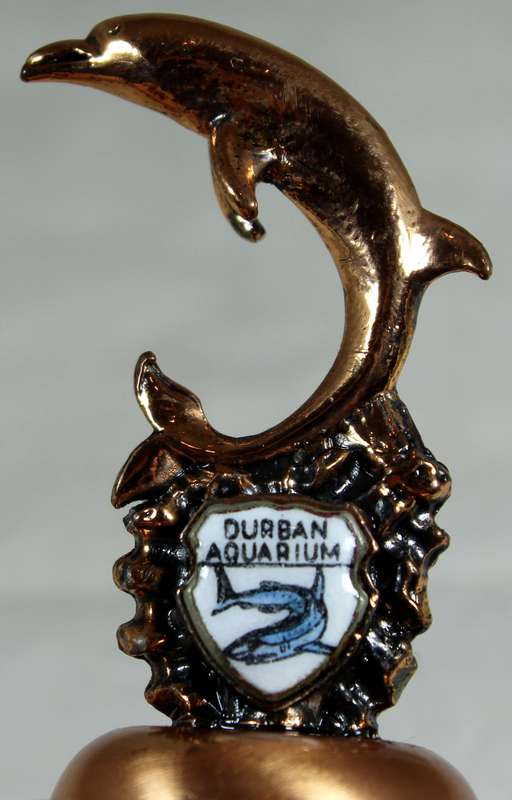 Souvenir copper bell - Durban aquarium with dolphin topped figure
