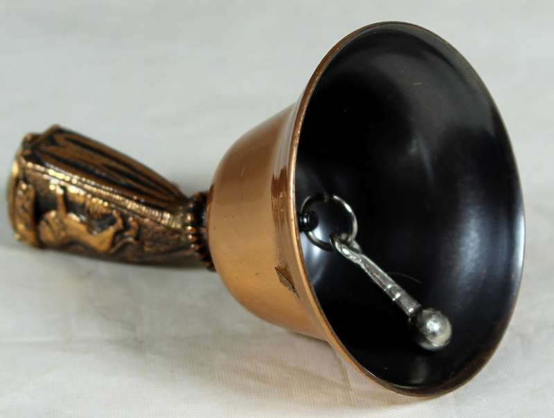 Souvenir copper bell - Umhlanga rock with lion topped figure embossed to shield