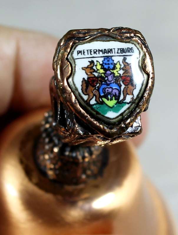 Souvenir copper bell - Pietermaritzburg with lion topped figure embossed to shield