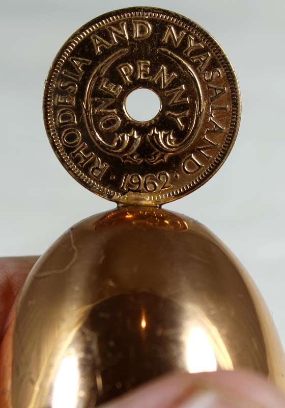 Souvenir copper bell with Rhodesia and Nyasaland coin