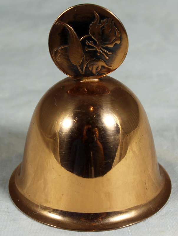Souvenir copper bell with coin depicting flowers