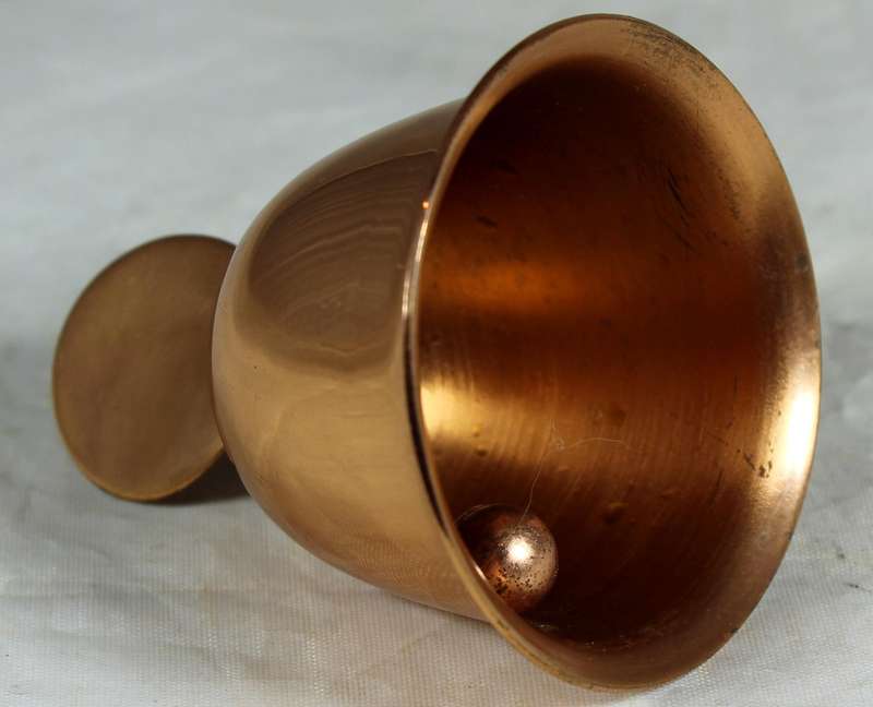 Souvenir copper bell with coin depicting flowers