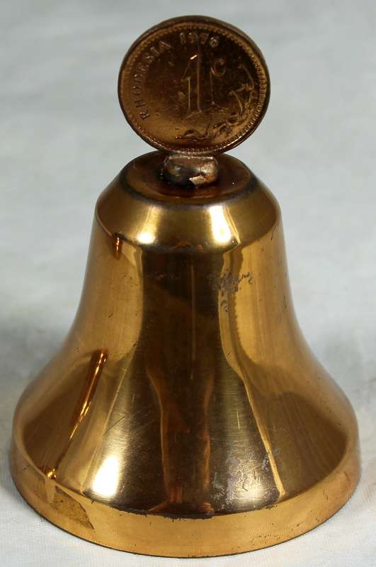 Souvenir copper bell with a Rhodesia 1c coin from 1976