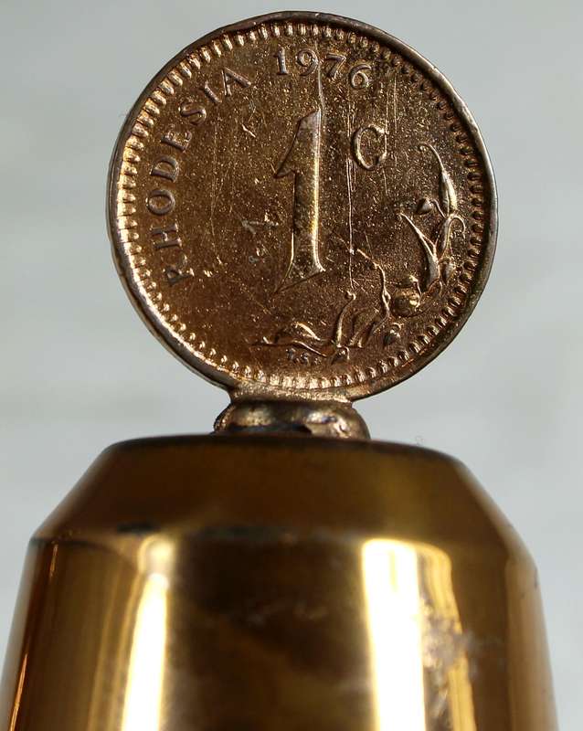 Souvenir copper bell with a Rhodesia 1c coin from 1976