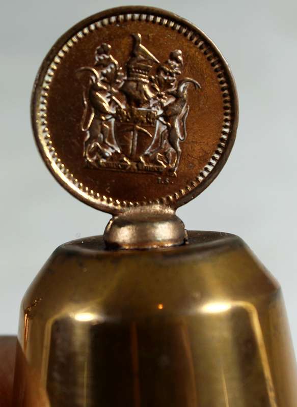 Souvenir copper bell with a Rhodesia 1c coin from 1976