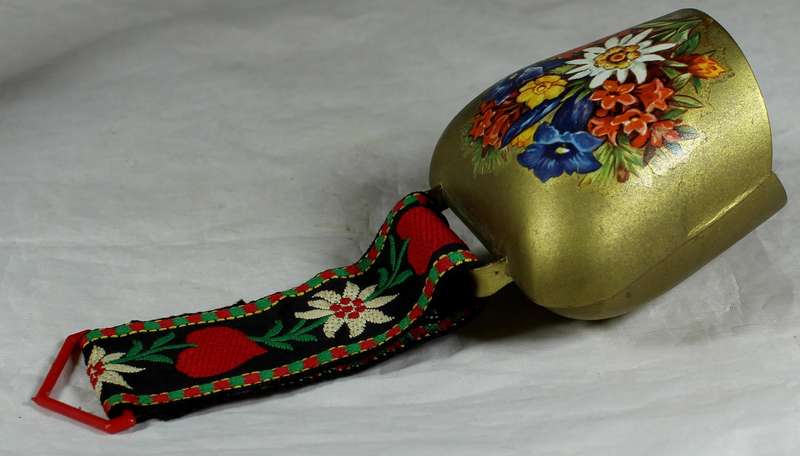 Cow bell with decorative strap