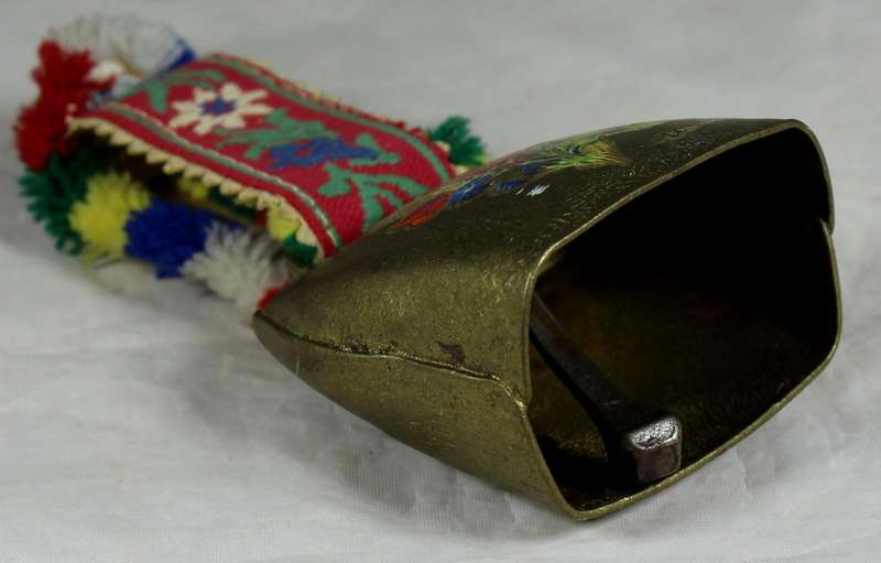 Cow bell with decorative strap