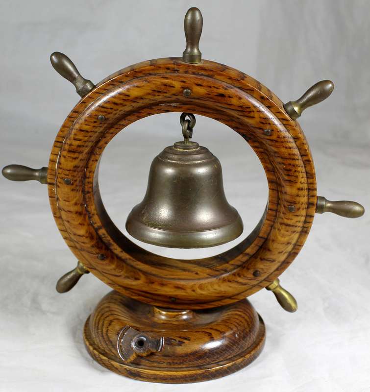 Wooden ships wheel with bell