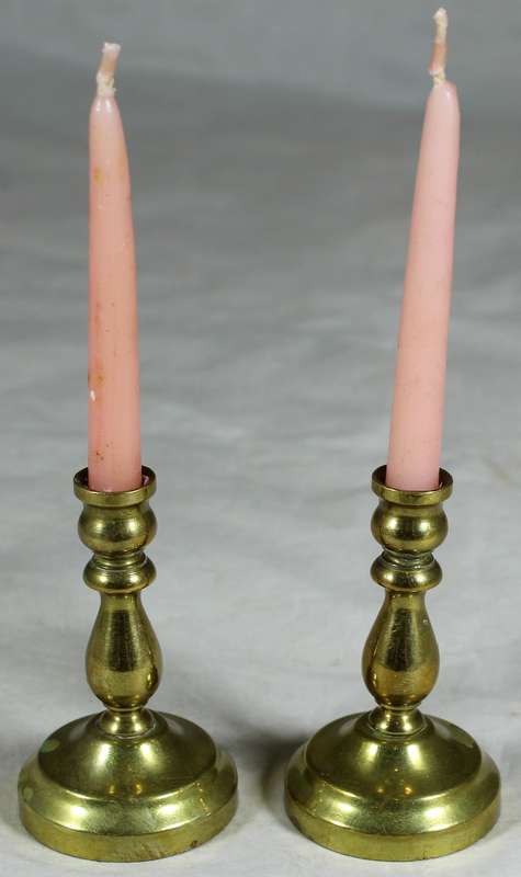 Pair of brass candle holders with candles