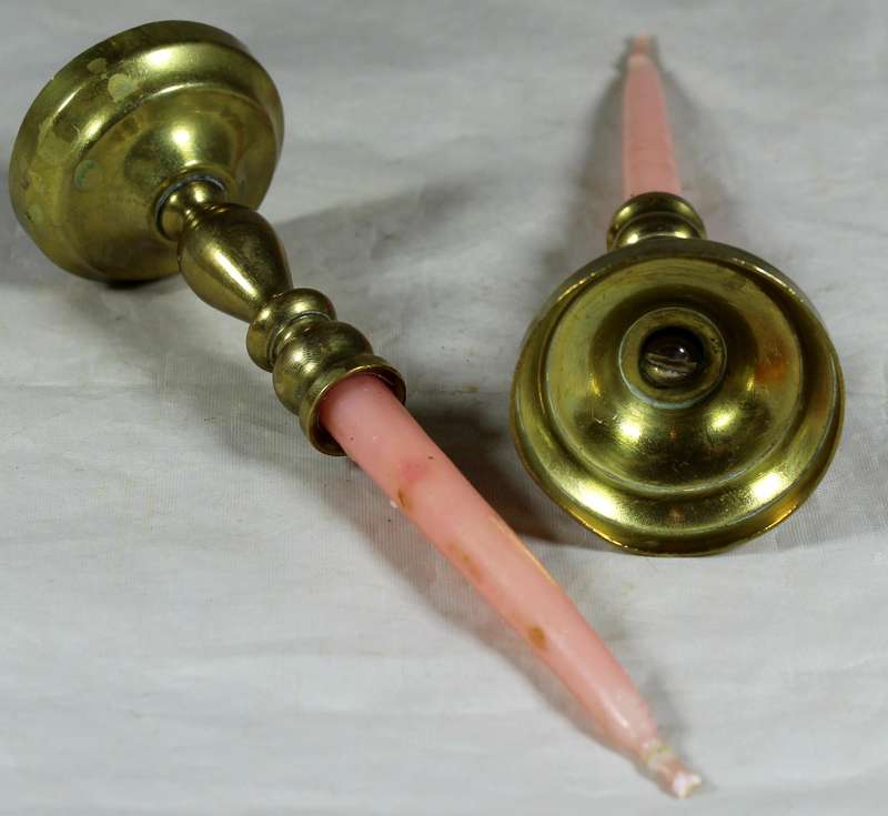 Pair of brass candle holders with candles