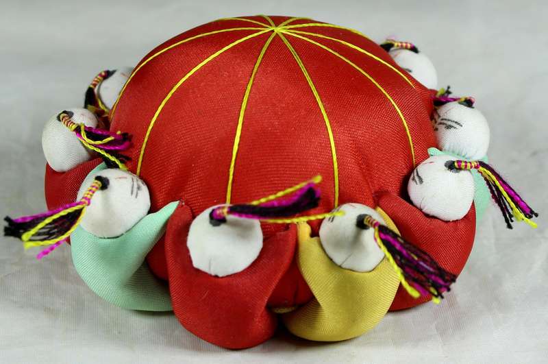 Oriental figures pin cushion