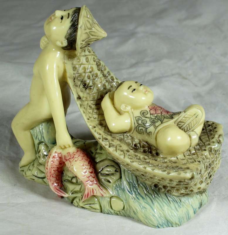 Japanese Netsuke figure - Man holding fish and pulling baby - Resin