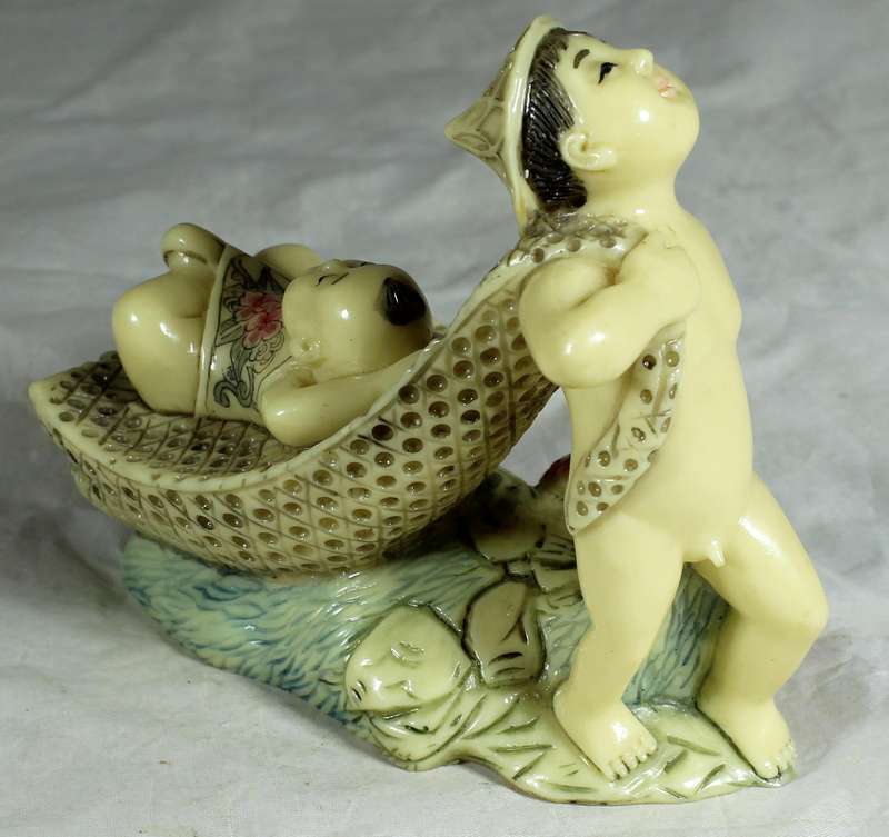 Japanese Netsuke figure - Man holding fish and pulling baby - Resin