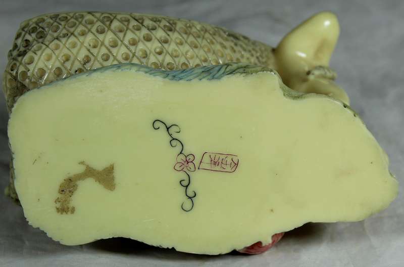 Japanese Netsuke figure - Man holding fish and pulling baby - Resin