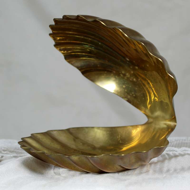 Porcelain baby in brass clam shell