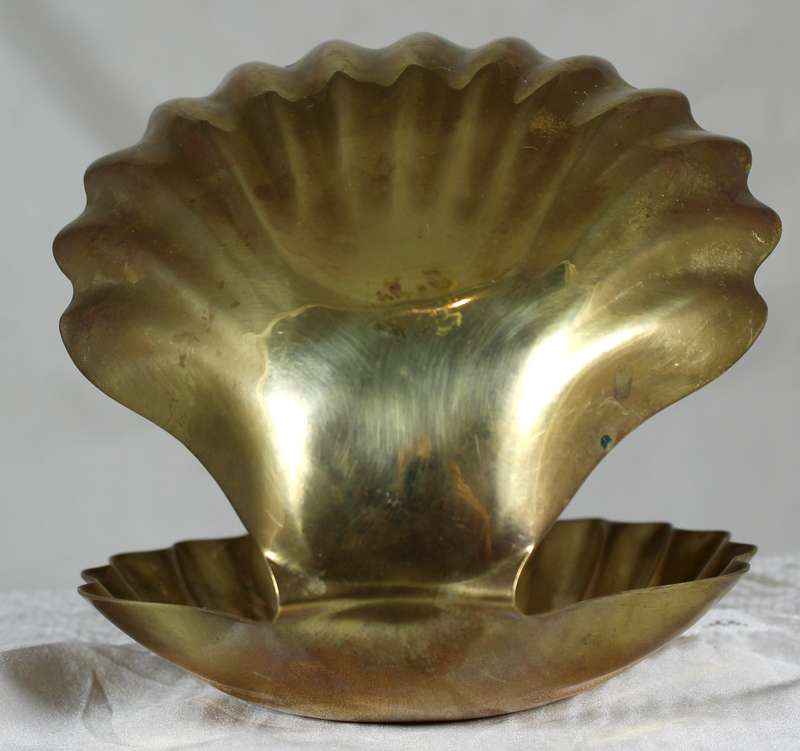 Porcelain baby in brass clam shell
