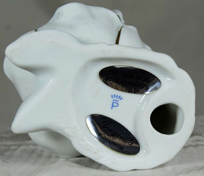 Porcelain baby in brass clam shell