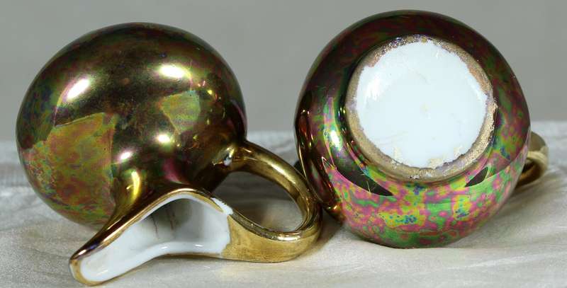 Miniature pair of golden covered pitchers