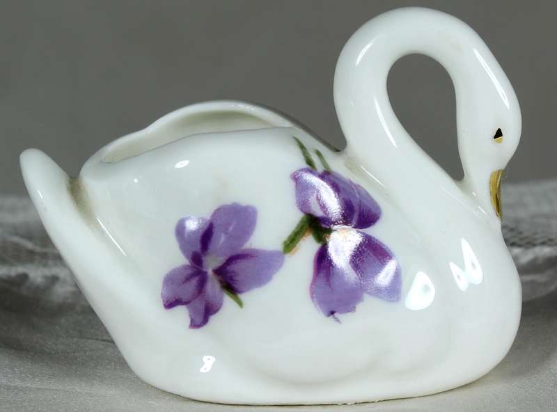 Miniature swan with purple violets