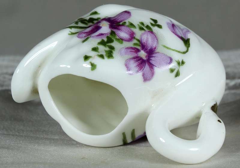 Miniature swan with purple violets