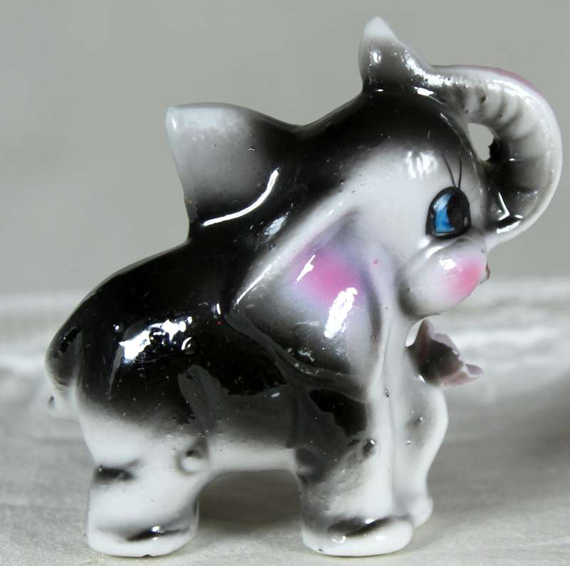 Miniature elephant with a flower