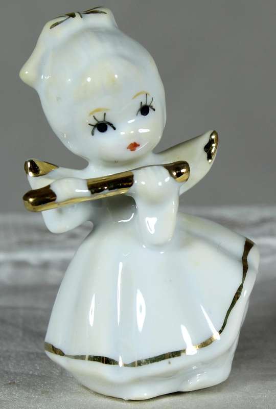 Miniature angel playing a flute