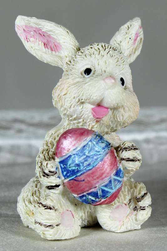 La Bell miniature rabbit holding an Easter egg