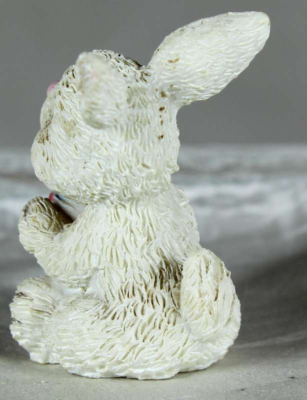 La Bell miniature rabbit holding an Easter egg