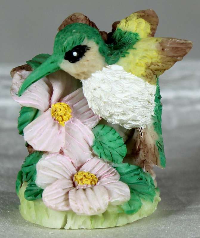Miniature humming bird on flowers