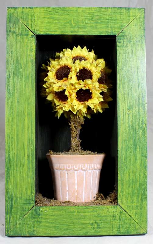 Artificial flowers in framed box