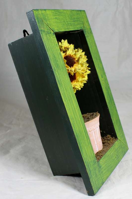 Artificial flowers in framed box