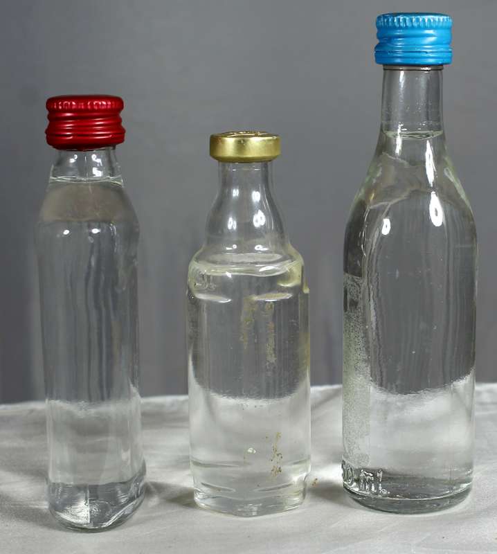 Empty liquor bottles - Trio of clear bottles