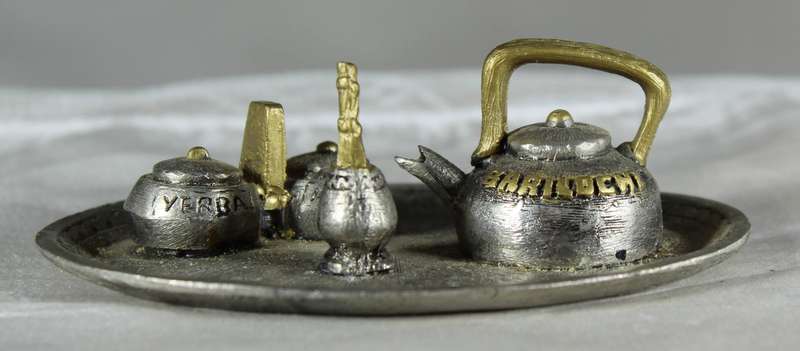 Miniature metal set of coffee pot items on a tray