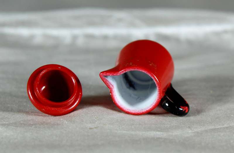 Miniature red painted metal coffee pot