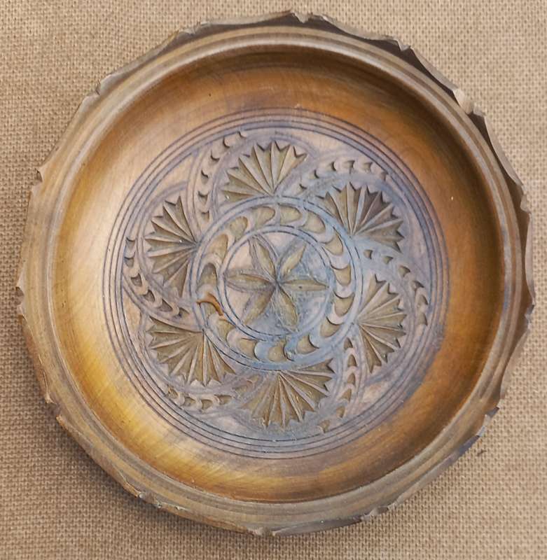 Vintage wooden plate. Round hand-carved