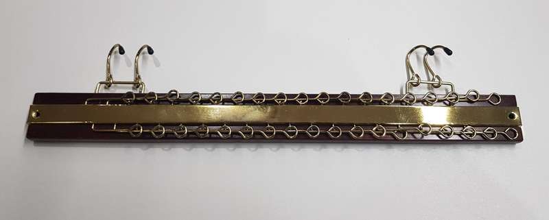 Necktie Rack: A wooden with gold tone Necktie rack with arms for 36 neckties.