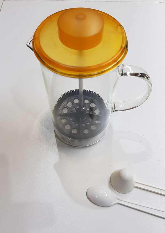 Glass coffee plunger with plastic lid and solid glass handle.
