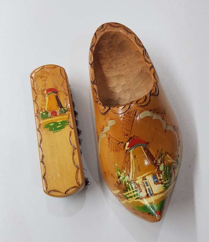 An Antique Handmade ornamental Dutch Wooden Clog with clothes brush wall hanging