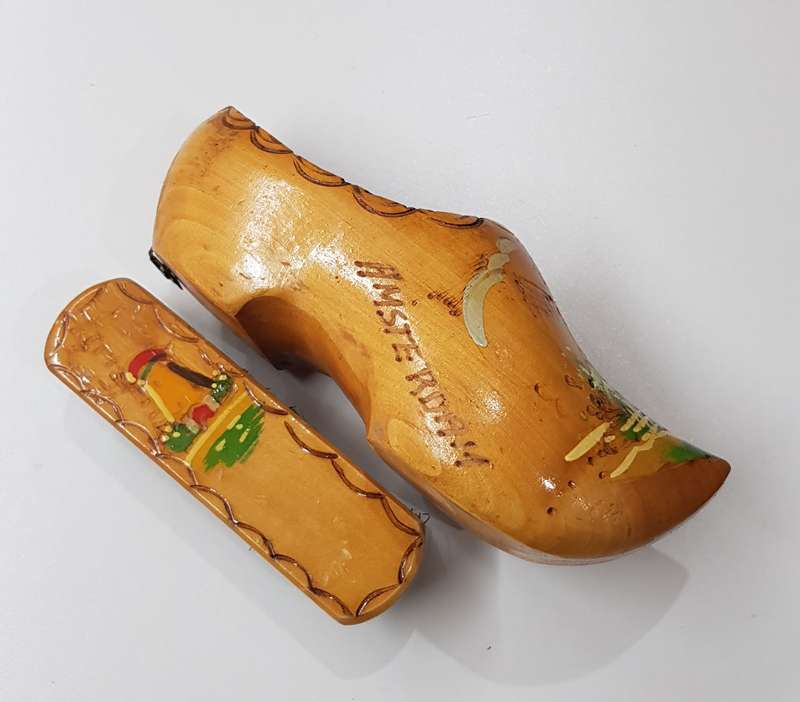 An Antique Handmade ornamental Dutch Wooden Clog with clothes brush wall hanging